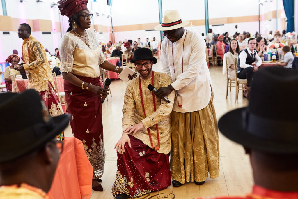 Groom kneeling before the elders during the traditional wedding ceremony