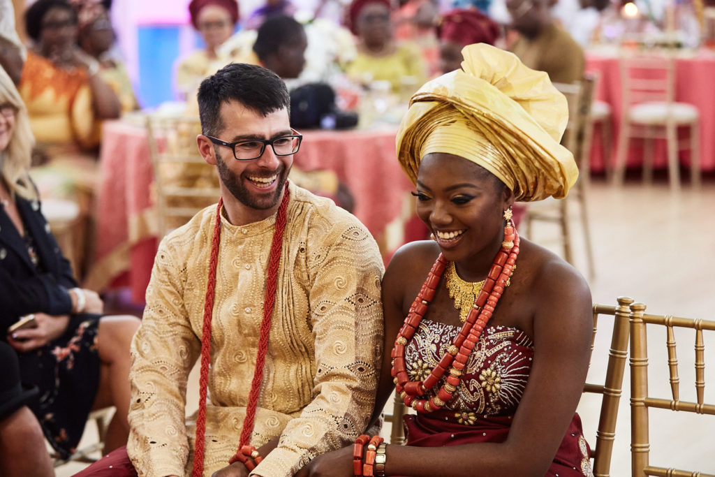 Bride and groom laughing together in traditional Itsekiri dress