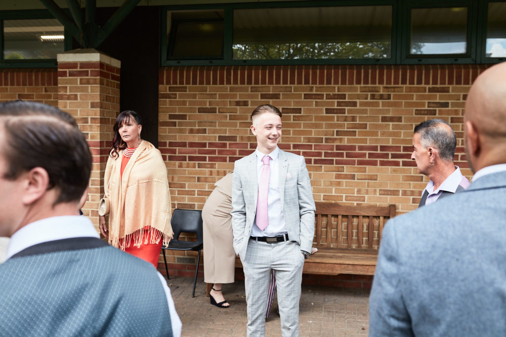 Wedding guests chatting outside the hall