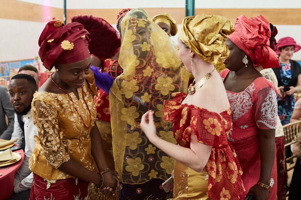 Women gathered round the veiled bride during the ceremony