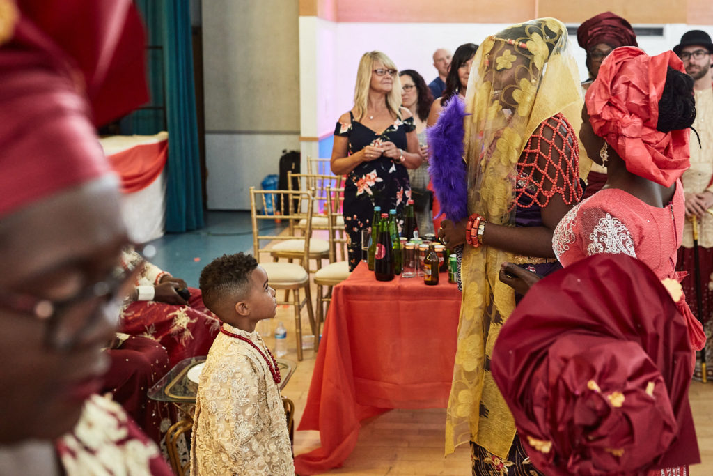Women in red head ties gathered round the bride