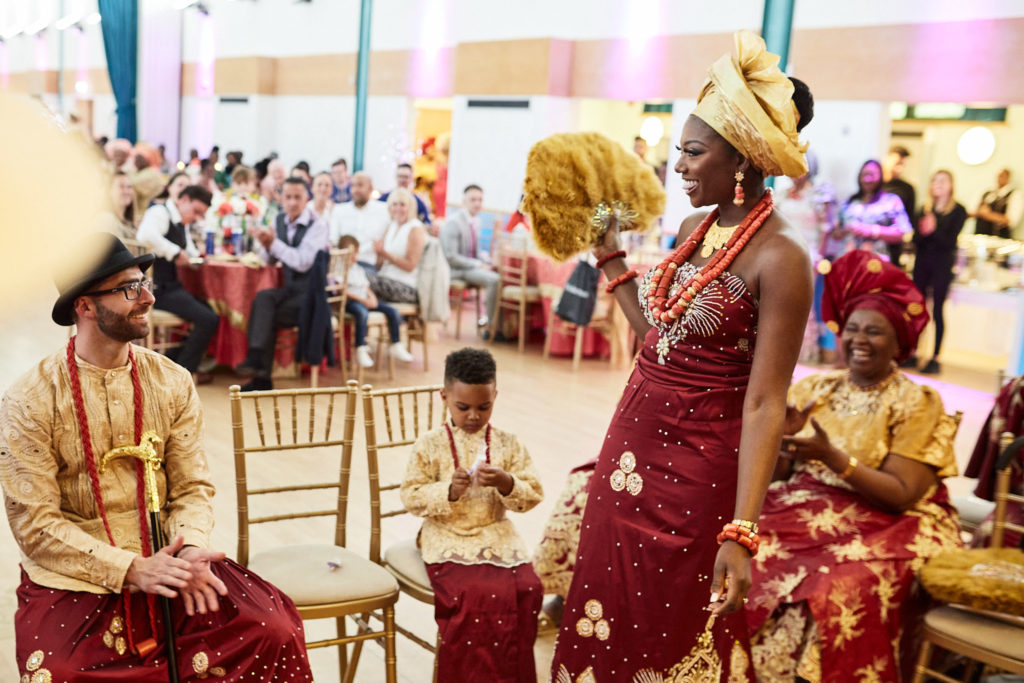 Bride standing before the seated elders during the traditional ceremony