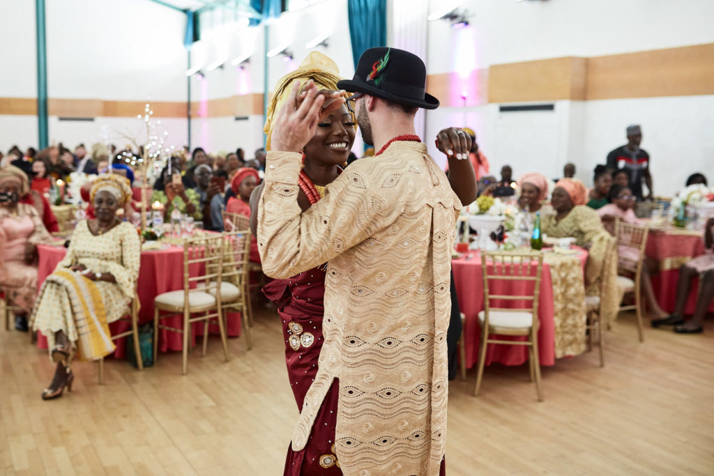 Groom dancing in the middle of the hall in traditional dress