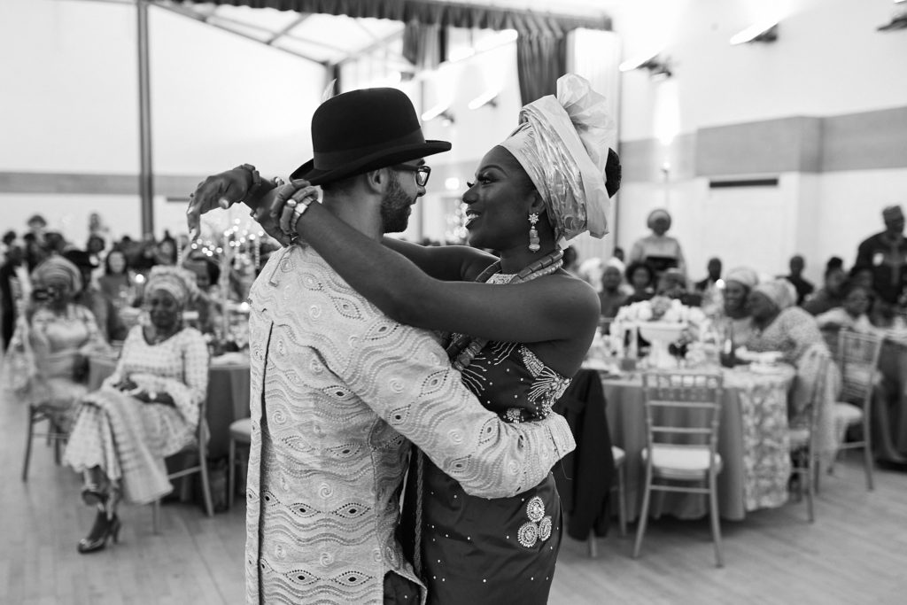 Black and white photo of the bride and groom embracing in the hall