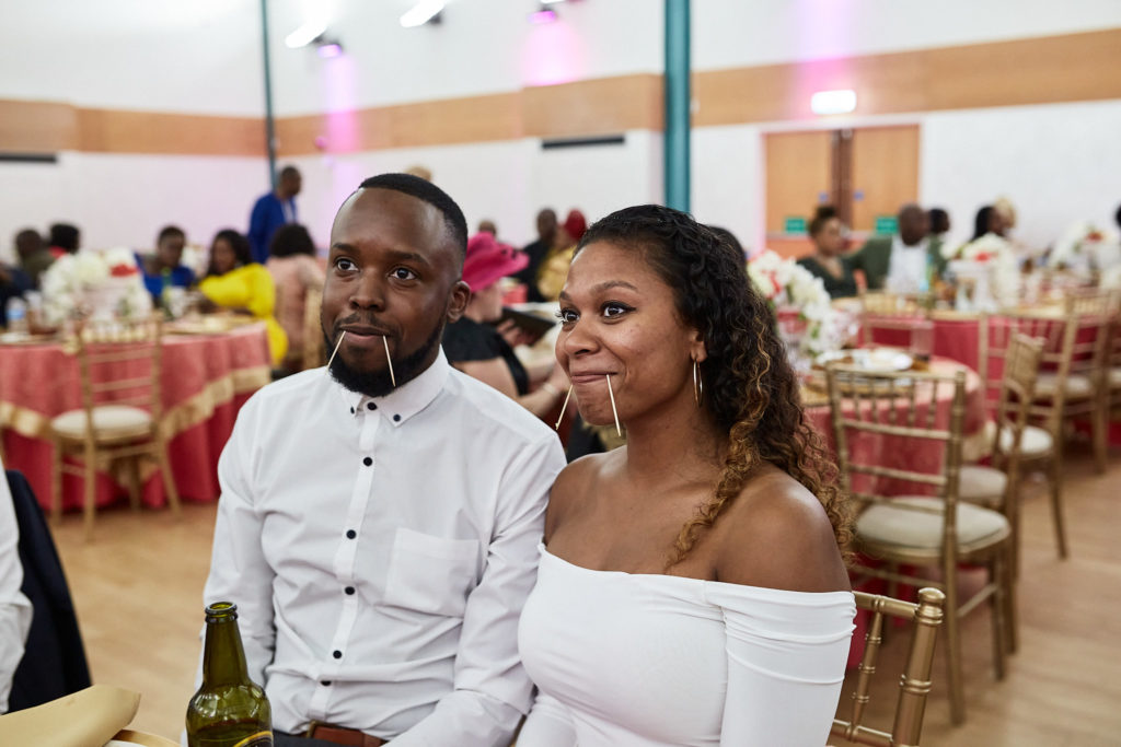 Two wedding guests sitting together at the reception