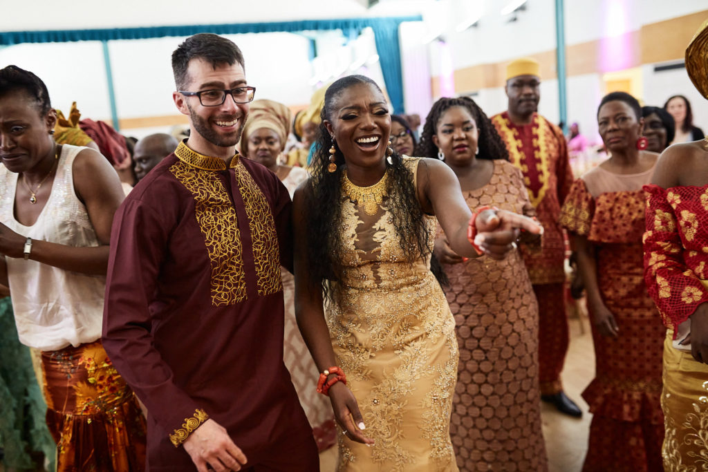 Bride and groom dancing with guests at the reception