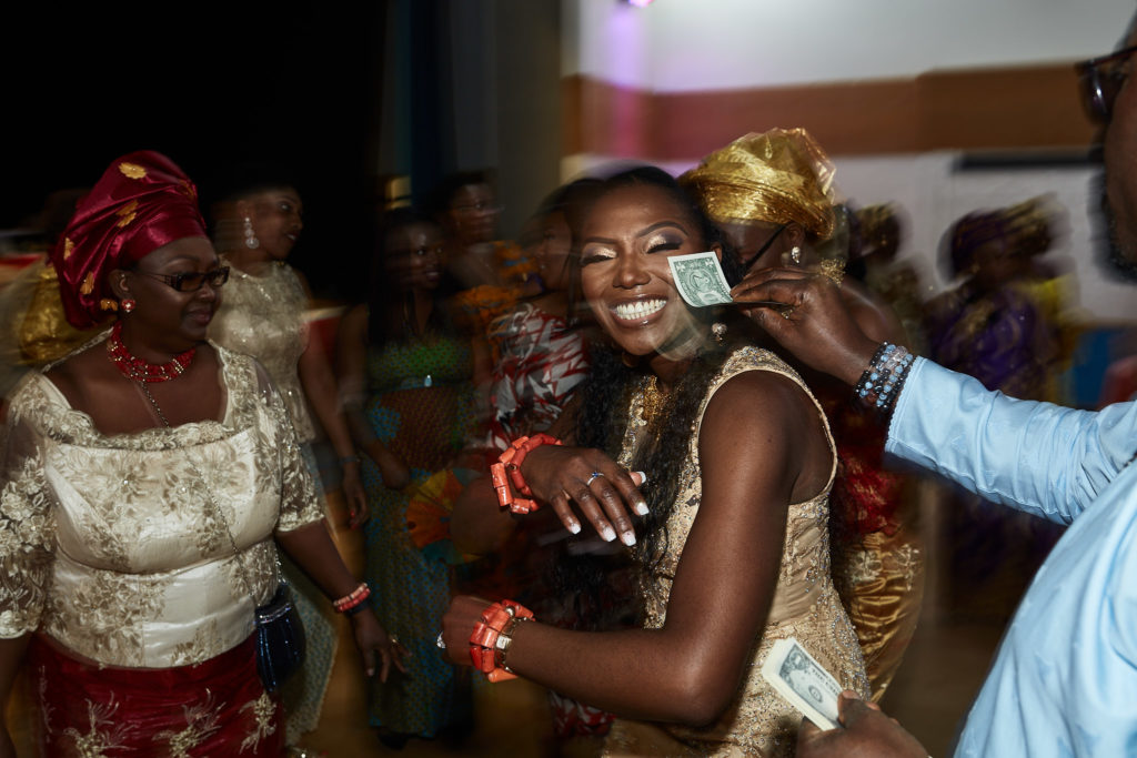 Bride dancing as a guest sprays her with money
