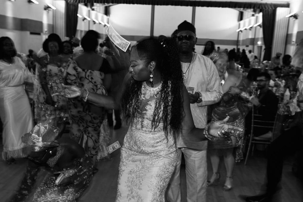 Black and white photo of the bride dancing among her guests