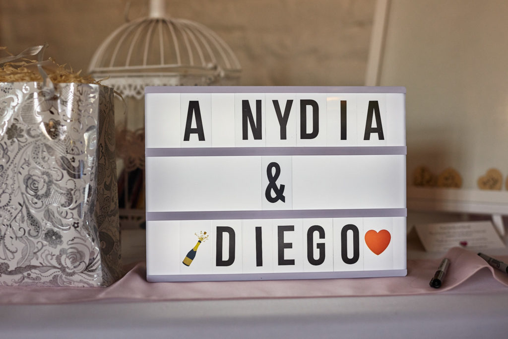 Lightbox sign spelling out the couple's names on a table