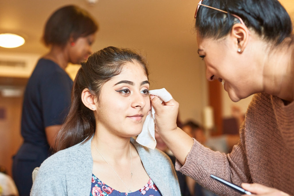 Bride having her make-up applied on the wedding morning