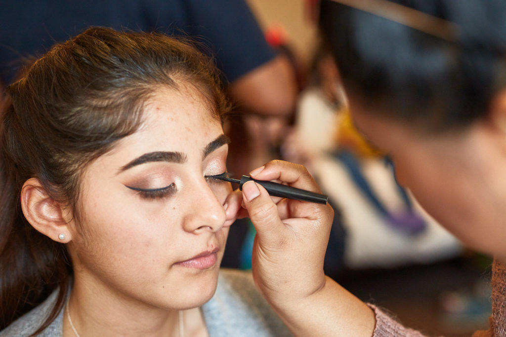 Close-up of a bridesmaid having her eye make-up applied