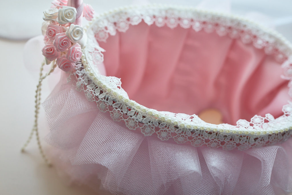 Pink satin-lined flower girl basket with a beaded trim