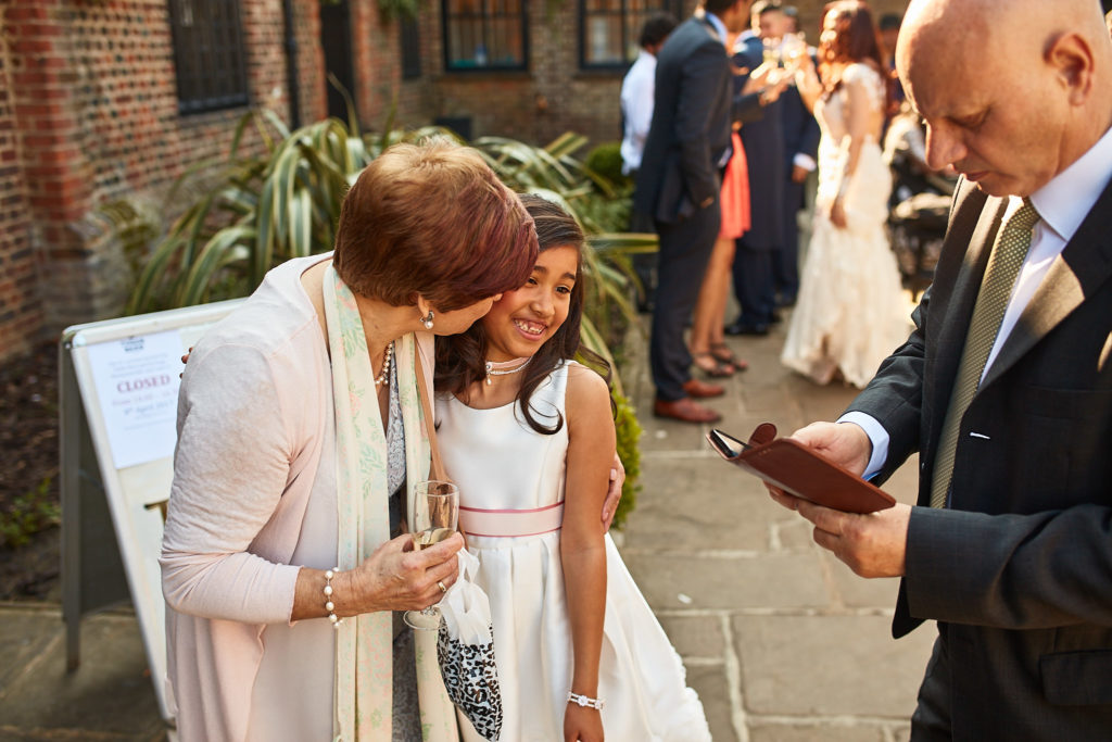 Wedding guests chatting in the courtyard