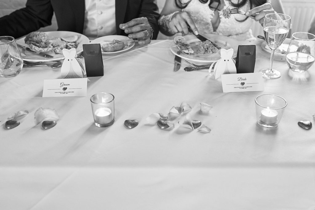 Black and white photo of bride and groom favour boxes on the top table