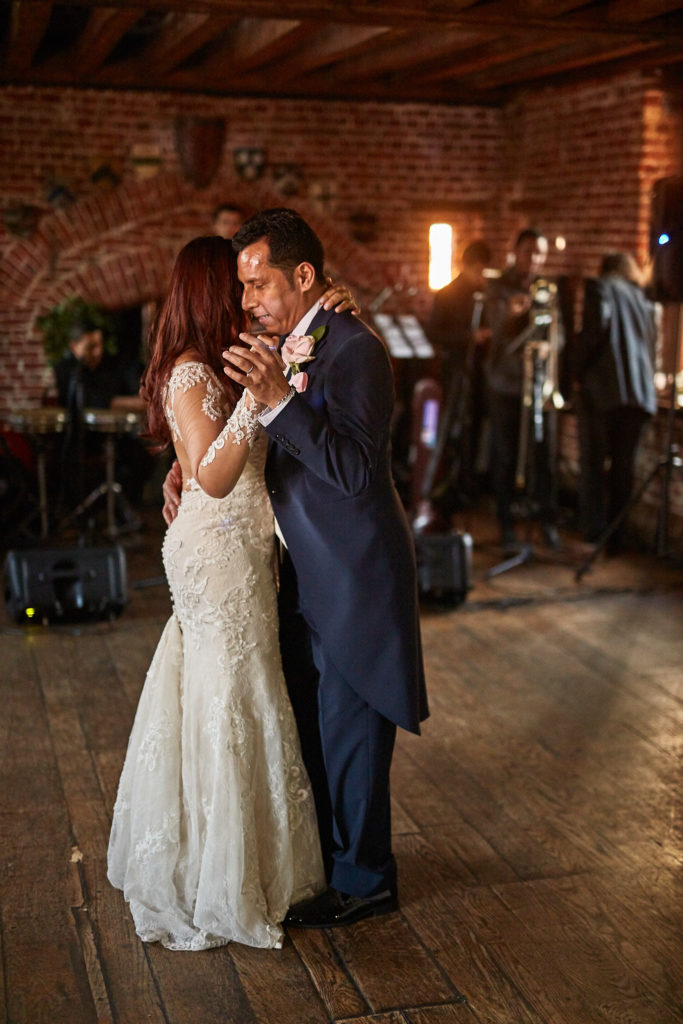 Bride and groom's first dance in the red-brick barn at Eltham Tudor Barn