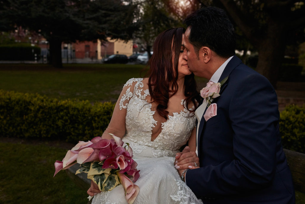 Bride and groom kissing in the gardens at Eltham Tudor Barn, south-east London