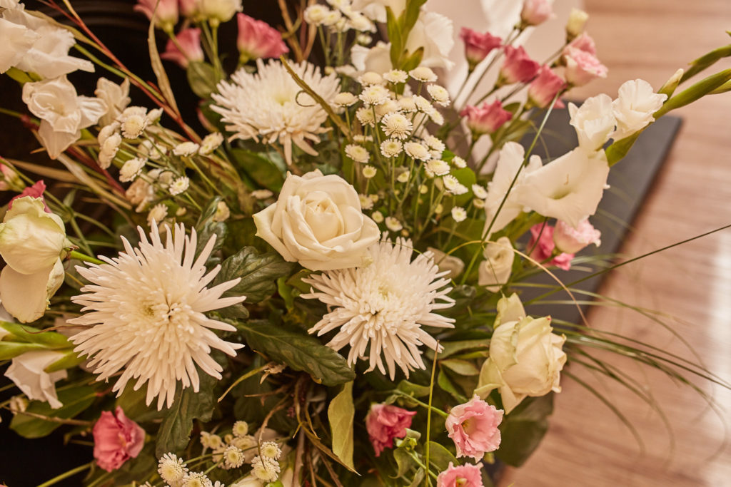 Arrangement of white chrysanthemums and pink flowers