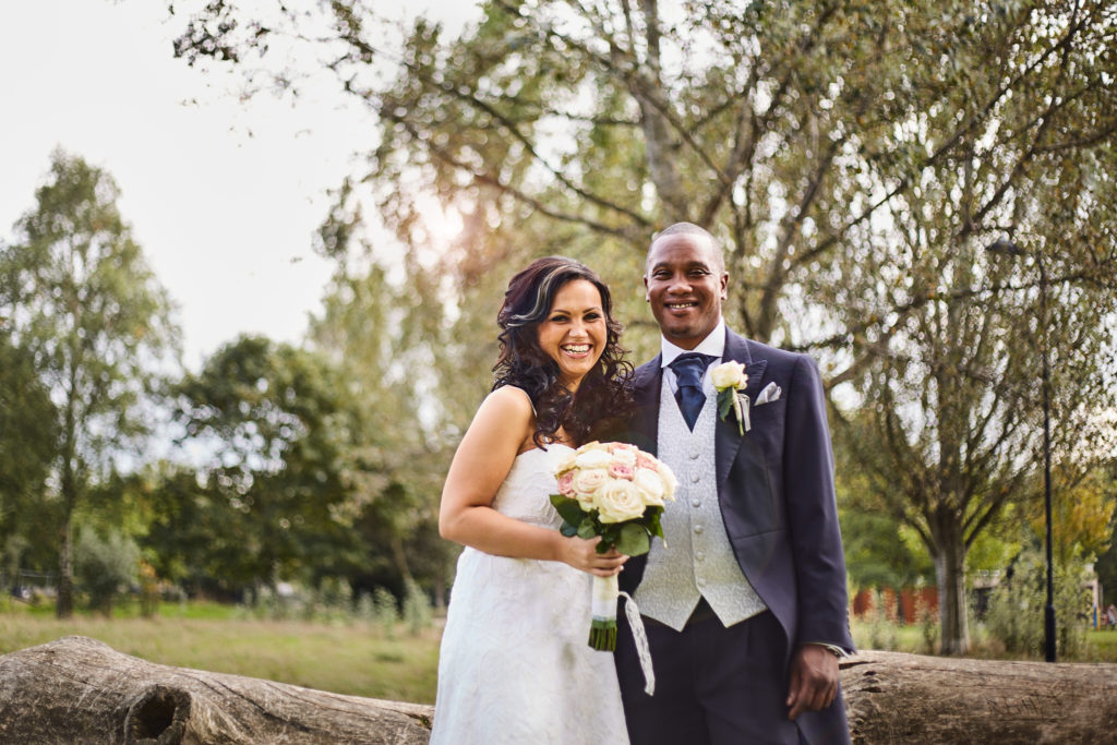 Bride and groom smiling together in a London park