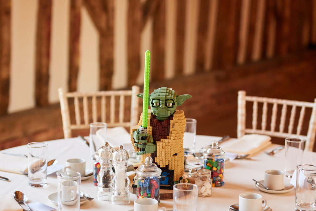 Lego Yoda model as a table centrepiece with jars of sweets at a Star Wars wedding at Villiers Barn