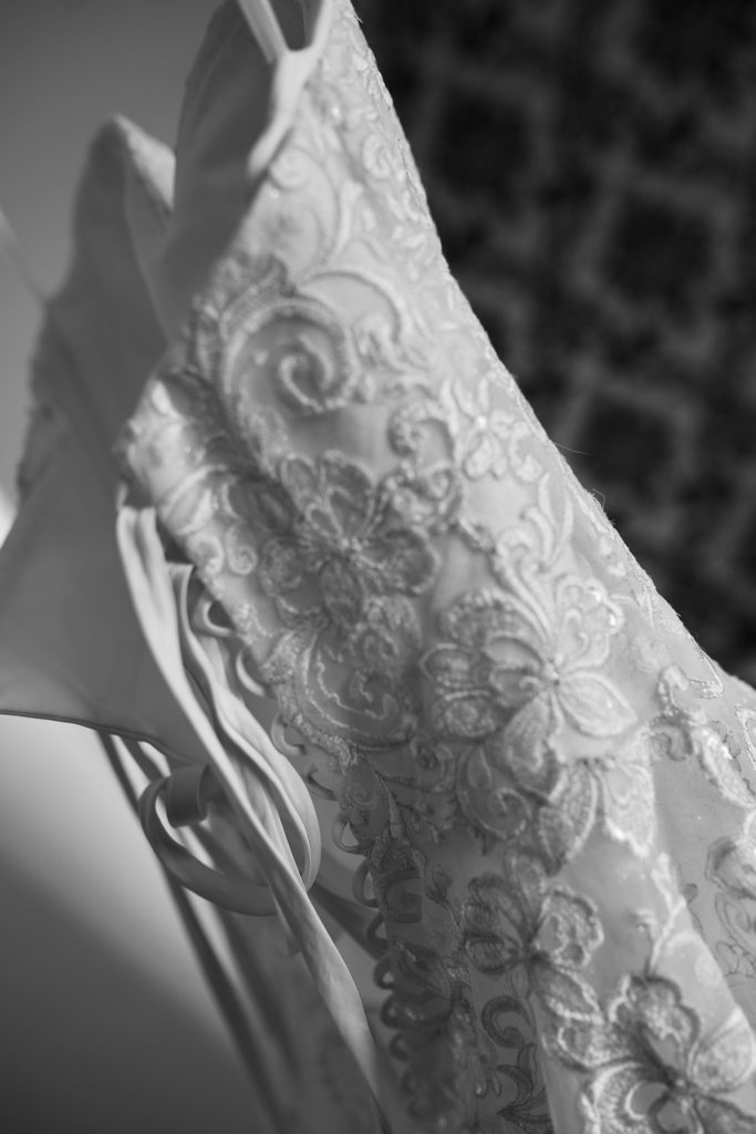 Black and white close-up of the embroidered lace on the wedding dress