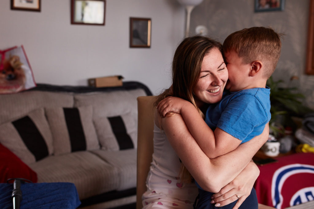 Woman hugging a young boy on the wedding morning