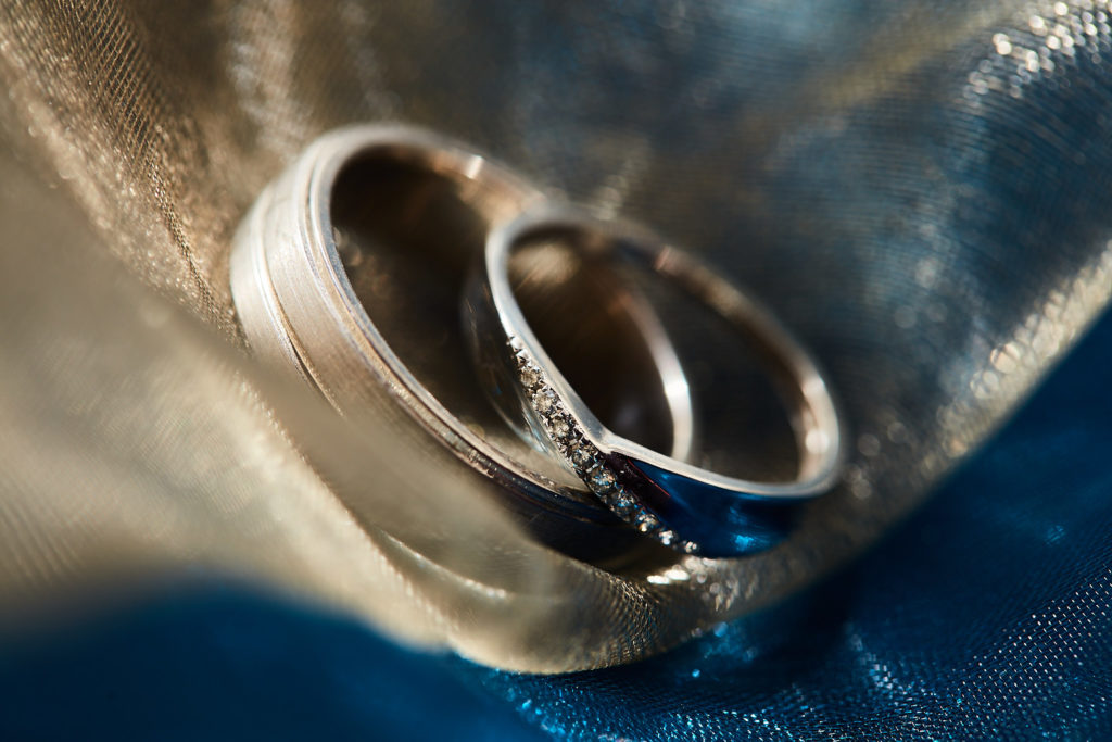 Close-up of wedding rings on blue fabric