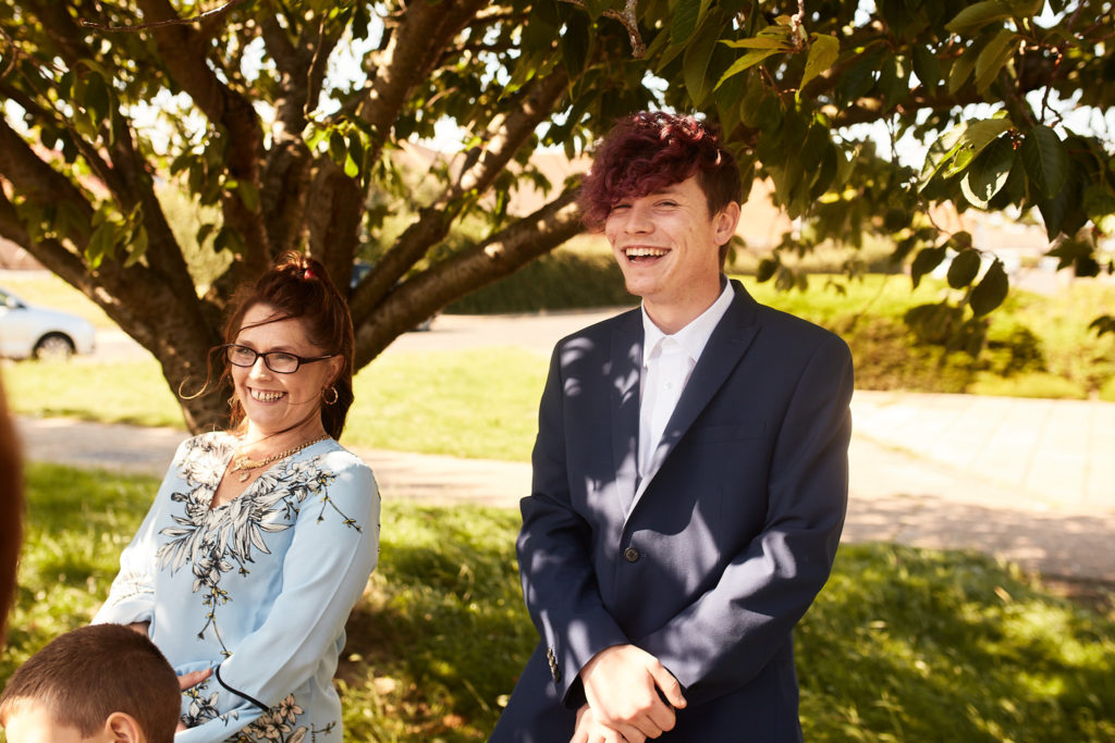 Wedding guests laughing in the sunshine