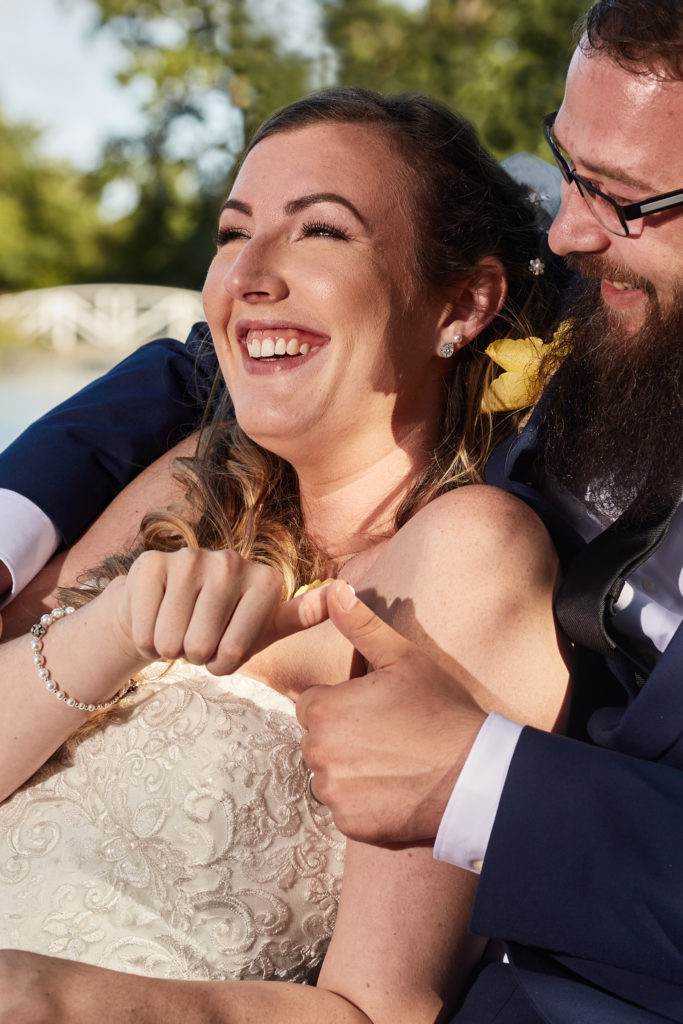 Close-up of the bride laughing in the groom's arms at Villiers Barn