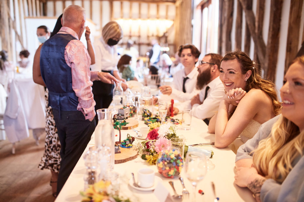 Wedding guests seated along a table during the wedding breakfast