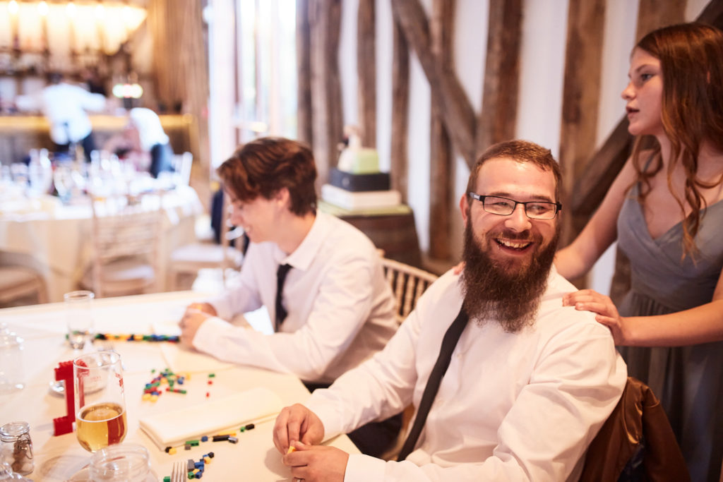 Groom laughing at the top table during the speeches