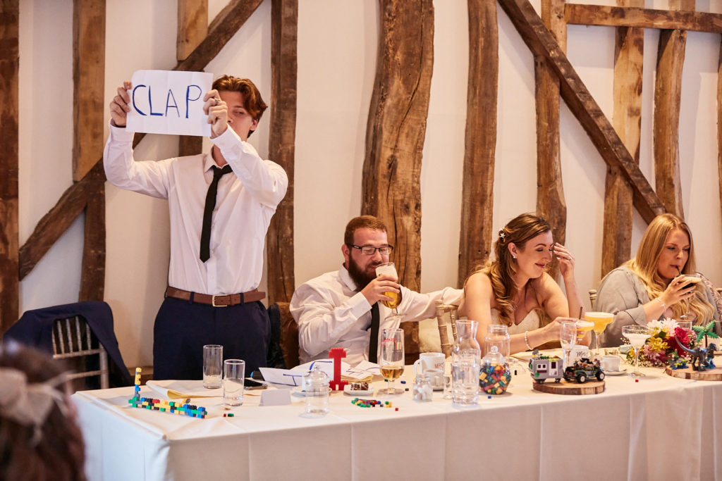 Best man holding up a sign during his speech