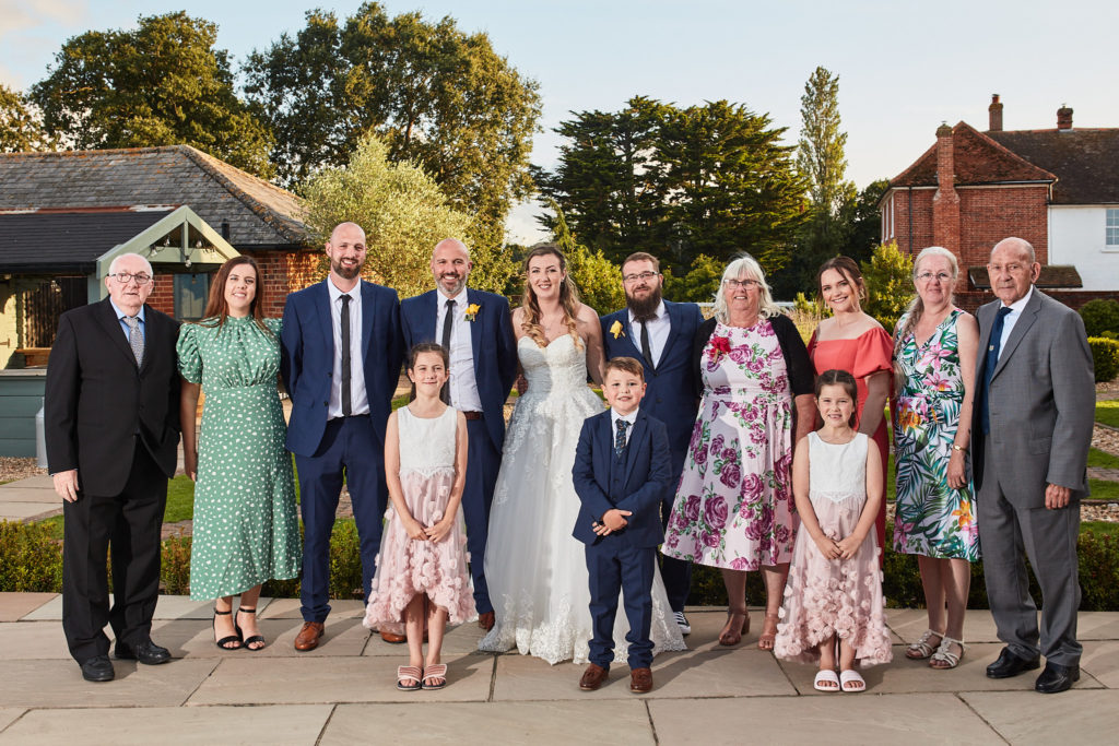 Bride and groom with their families outside Villiers Barn