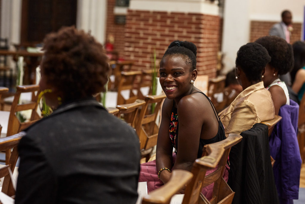 Wedding guests chatting in the church pews