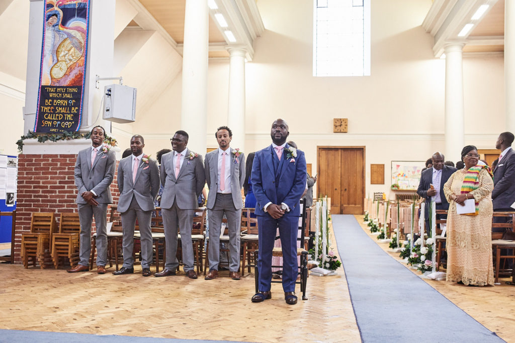 Groom and groomsmen lined up at the front of the church