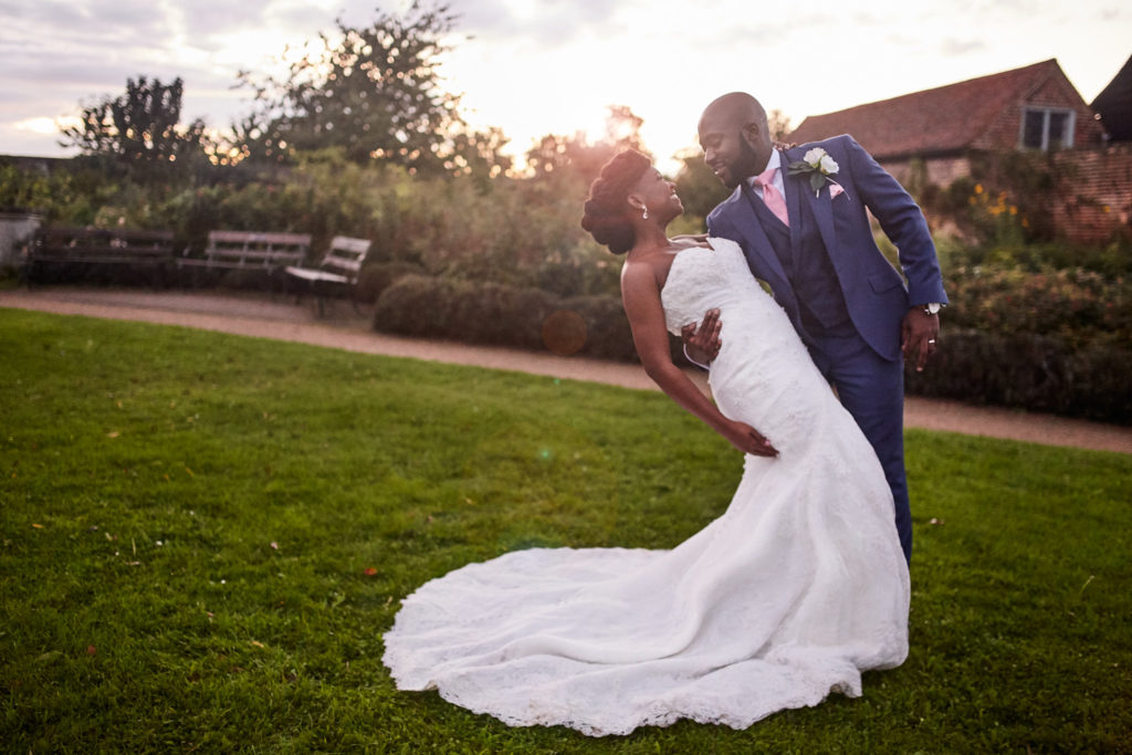 Groom dipping the bride on the lawn at sunset at Forty Hall