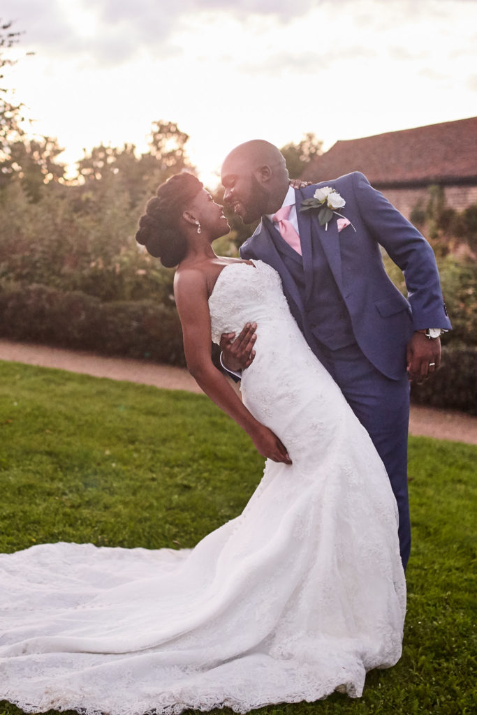 Bride and groom kissing as he dips her at sunset at Forty Hall, north London