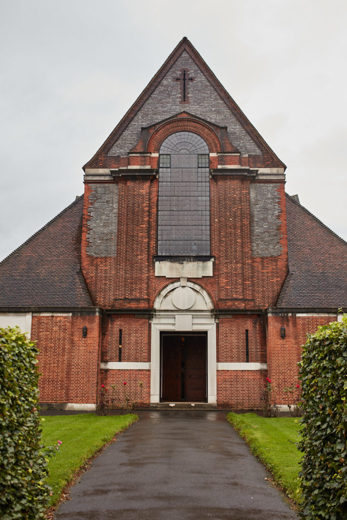 Red-brick church with a path leading to the door