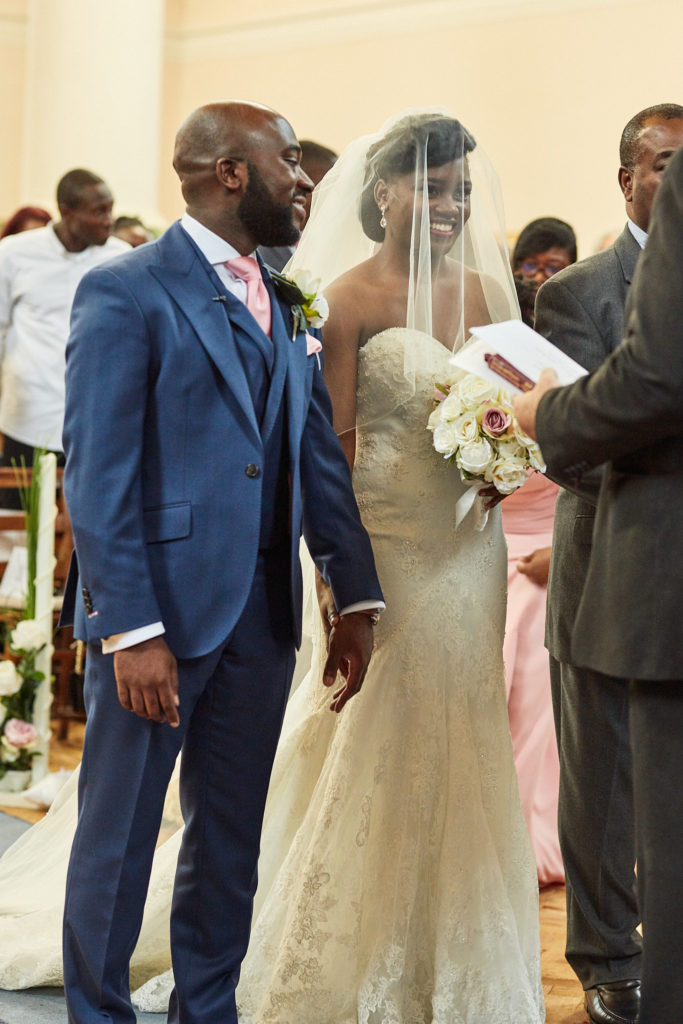 Bride and groom standing side by side at the start of the ceremony