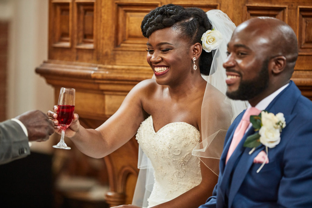 Bride and groom raising a glass during the service