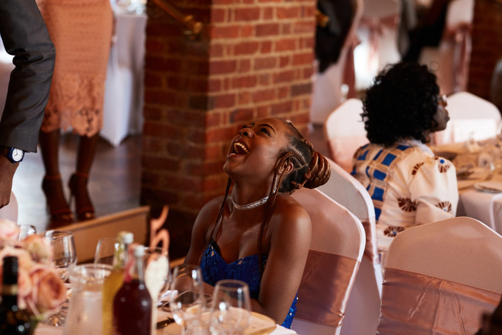 Wedding guest laughing at the table