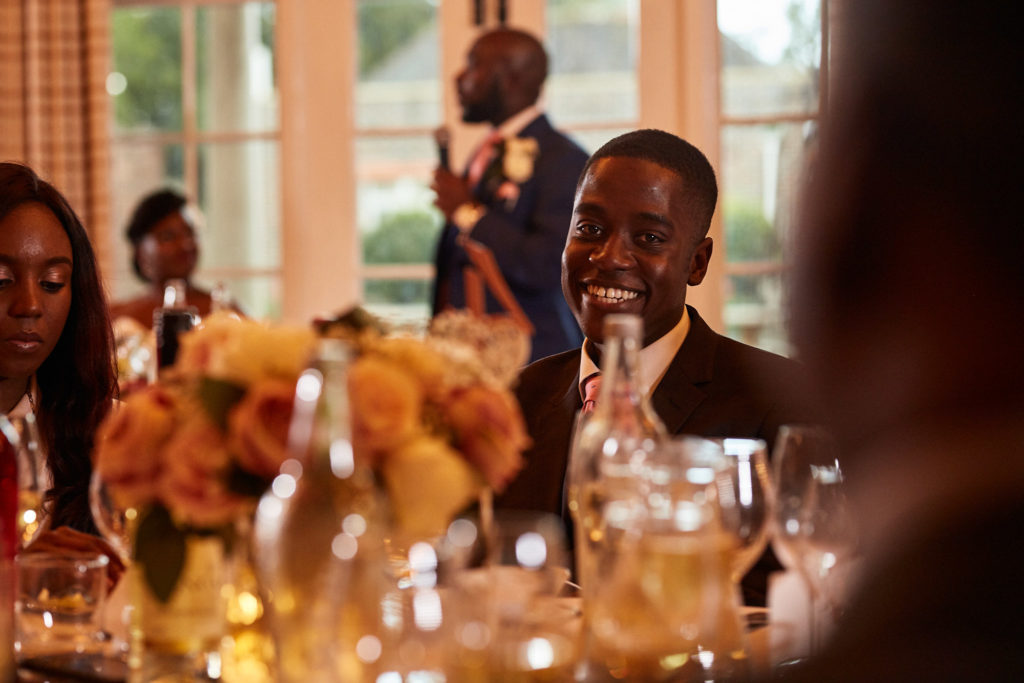 Wedding guest smiling at the table in warm evening light