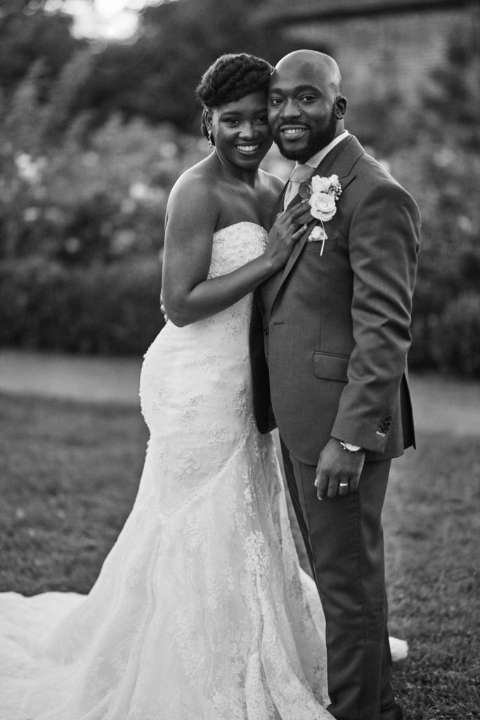 Black and white photo of the bride and groom smiling arm in arm at Forty Hall