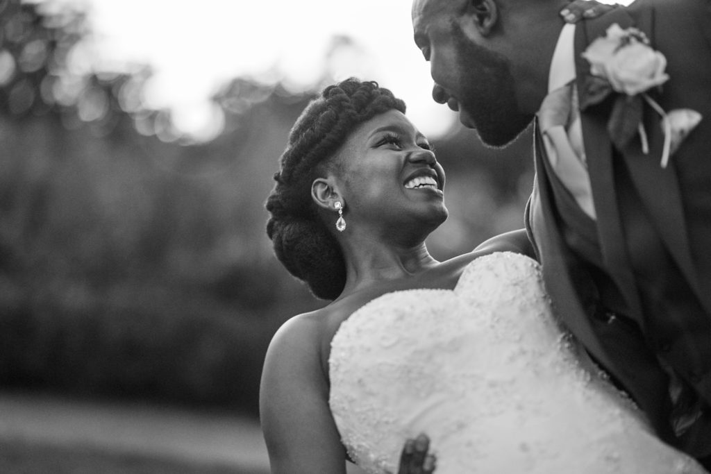 Black and white photo of the bride laughing up at the groom at Forty Hall