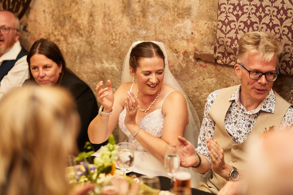 Bride and groom laughing at the table