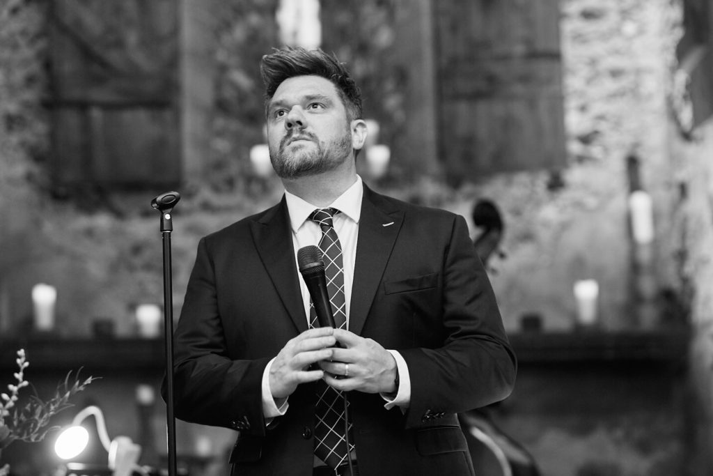 Black and white photo of a singer performing with a microphone