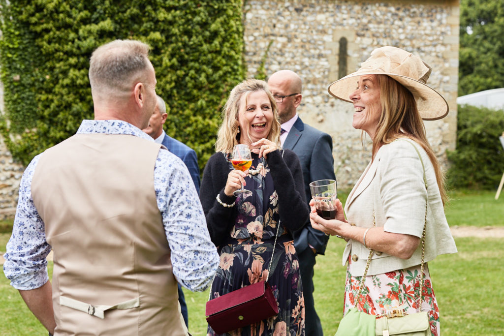 Wedding guests chatting on the lawn