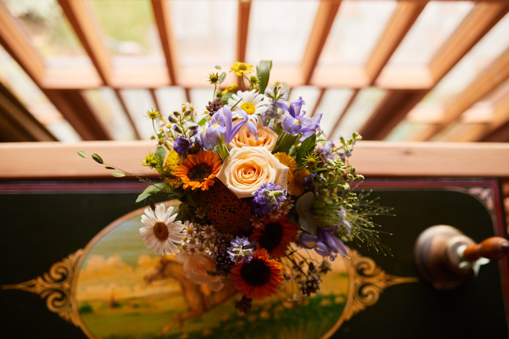 Arrangement of sunflowers and wildflowers on a ledge