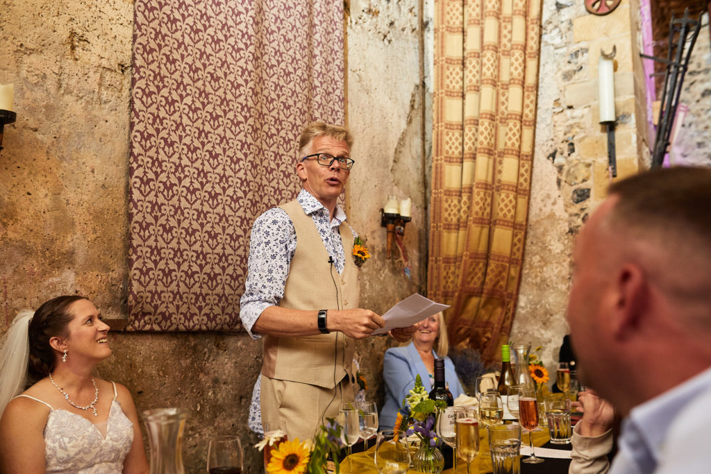 Groom giving his speech in the candlelit church