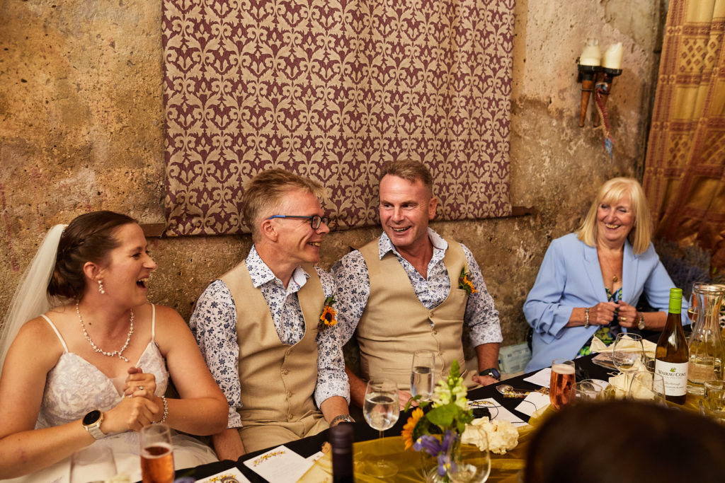 Bride and groom laughing at the top table