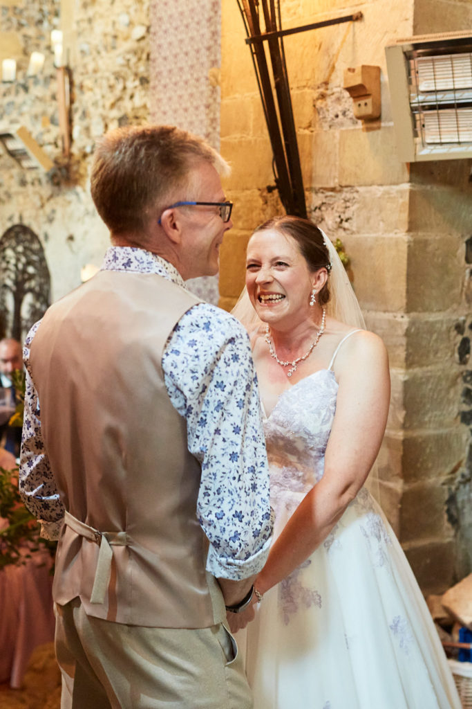 Bride and groom laughing during their wedding vows